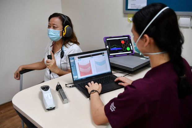  ​A patient undergoing a pure-tone audiometry to measure her hearing sensitivity at Pioneer Polyclinic on Oct 26, 2021. ST PHOTO CHONG JUN LIANG