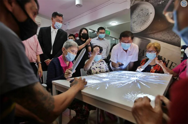  ​Health Minister Ong Ye Kung (second from right) taking part in a game with seniors at the THK Senior Activity Centre @ Beo Crescent. ST PHOTO GIN TAY