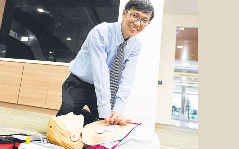 showing how to use an automated external defibrillator yesterday. He says Singapore still has some way to go in CPR training.