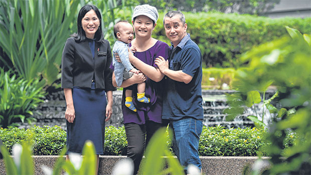 carrying her 10-month-old son Tok Yuan Yi, with husband Sam Tok Hoe Tooi, 46, and Dr Lim Geok Hoon. Madam Wong underwent the minimal-scar mastectomy 10 days after giving birth to Yuan Yi. ST PHOTO KUA CHEE SIONG