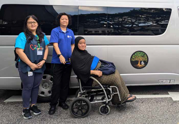 Patients like Mdm Asnah Salim (in wheelchair) benefit much from the assistance rendered by Ms Ng Swee Leng (left), who is a volunteer with SGH's Medical Chaperone programme. The programme is supported by social service agencies, such as the Thye Hua Kwan Moral Charities, which provide transport to and from SGH Campus.   