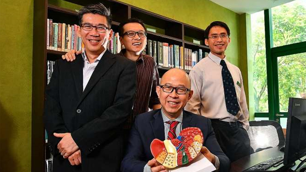  ​​From left Associate Professor Roger Foo and Dr Zhai Weiwei from the Genome Institute of Singapore, with Professor Pierce Chow (seated), from the National Cancer Centre Singapore, and Dr Wan Wei Keat from Singapore General Hospital. Their work suggests liver cancer treatment should be customised to each patient.  ST PHOTO LIM YAOHUI