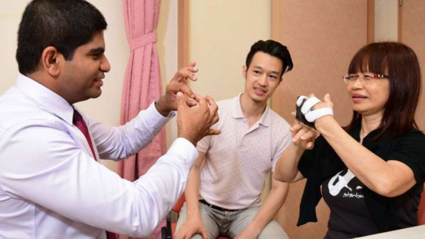  ​Prof Nagaendran (left) with a patient, Ms Low, who began showing symptoms two years ago, says her son, Mr Lim. She is now on medication and an exercise and mental stimulation programme.  Photo Dios Vincoy Jr for The Straits Times