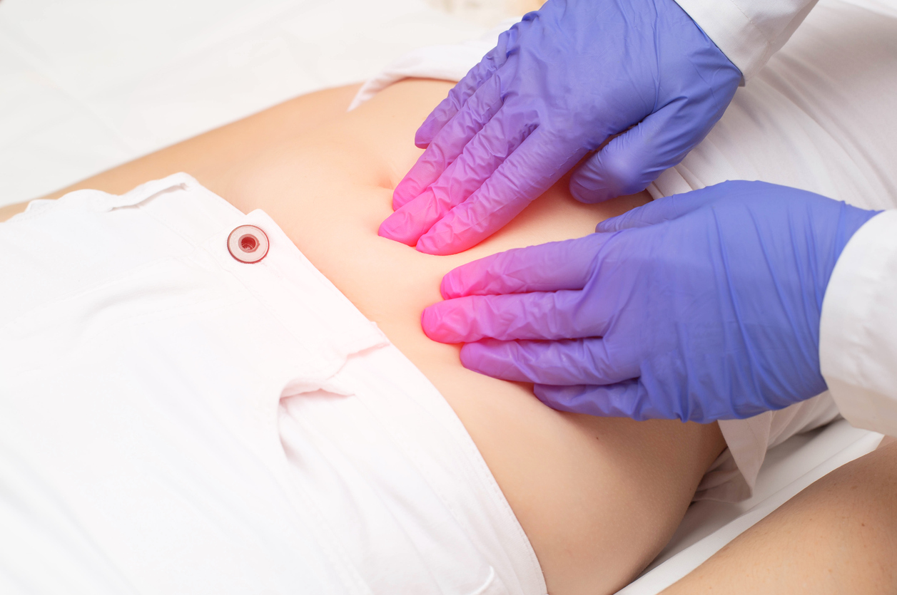 doctor checking the stomach of the patient with uterine fibroids